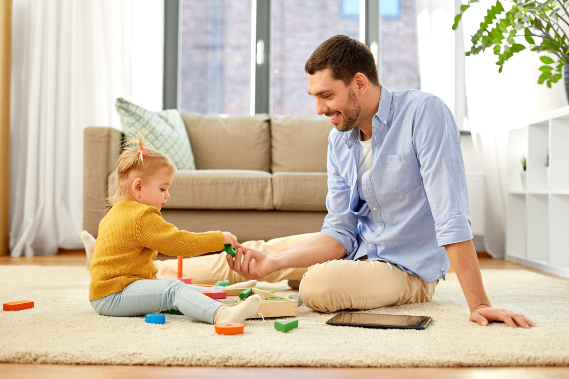 A parent and child playing together on the floor in a peaceful home environment.